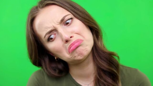 Woman rolling her eyes in annoyance on green screen background