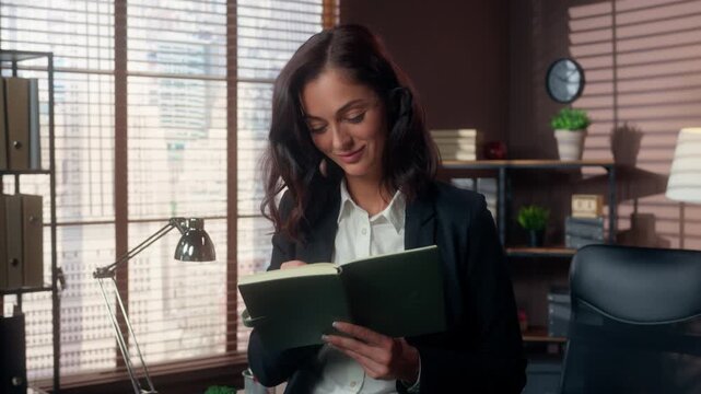 Focused Caucasian business woman writing notes in office thinking about ideas female businesswoman planning notebook diary tasks pondering concentrated smiling lady information contemplation indoor