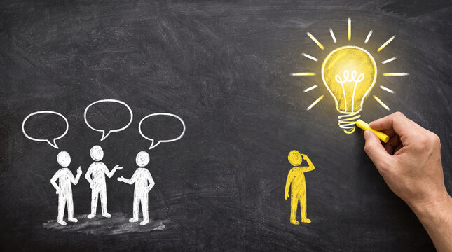 Chalk drawing of figures and a lightbulb on a blackboard, representing idea generation and collaboration, symbolizing innovation and teamwork