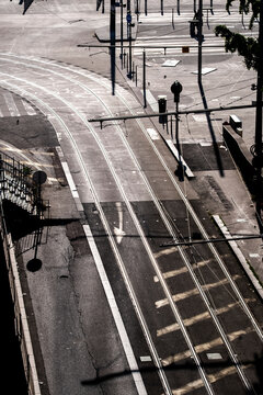 Elevated view of tram tracks and an urban intersection with pedestrians showing transport infrastructure street geometry and everyday movement in the city