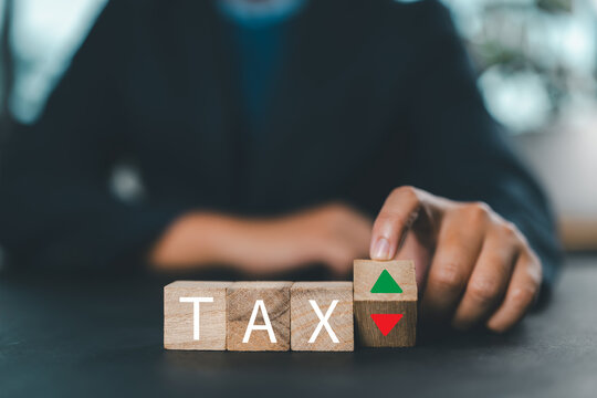 Wooden blocks with the word Tax and up and down arrows. Business and finance concept. Taxes and taxation. The tax burden