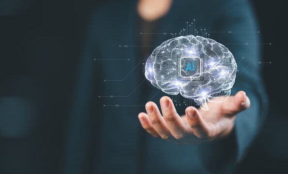 Businessman holding brain of artificial intelligence ai to apply in content creator or creative assistance by big data technology machine learning on natural language processing NLP.