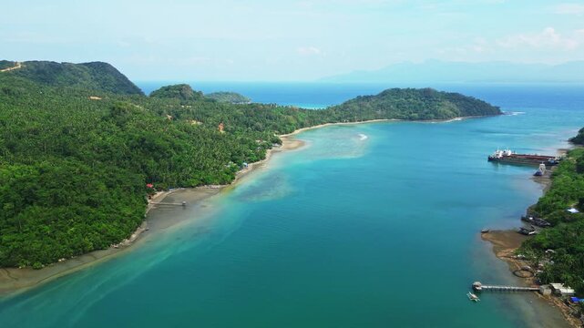 Drone footage ascending from the coastal waters of Sula Angling Spot to reveal a wrecked tanker and the expansive blue seascape surrounding Cagraray Island, Albay.