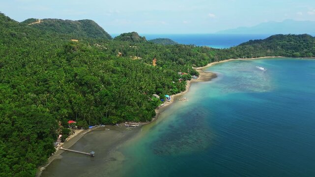 aerial landscape of Sula Angling Spot with a wrecked tanker standing out against vivid blue tropical waters and the lush coastline of Cagraray Island.