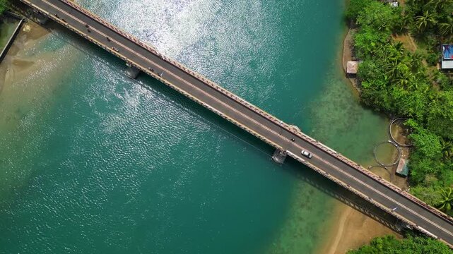 Overhead drone view of the Sula Bridge area on Cagraray Island, revealing Angel's Corner, Misibis Road and a vivid blue tropical lagoon near Bacacay, Albay.