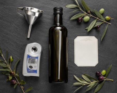 Olive Oil Quality Testing Flat Lay with Bottle, Refractometer and Blank Label