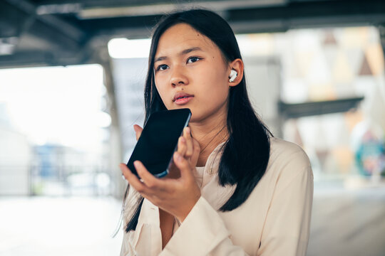 woman talking and command an AI voice assistant on a smartphone as a conceptual backdrop for artificial intelligence technology communication phone innovation virtual assistant and smart lifestyle