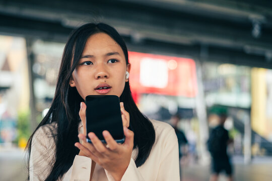 woman talking and command an AI voice assistant on a smartphone as a conceptual backdrop for artificial intelligence technology communication phone innovation virtual assistant and smart lifestyle