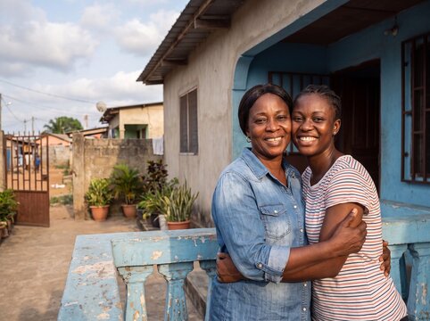 Ivorian mother and daughter embracing at home