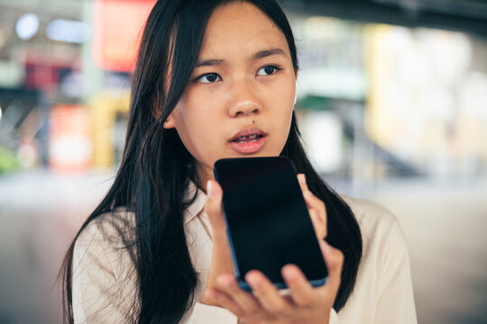 woman talking and command an AI voice assistant on a smartphone as a conceptual backdrop for artificial intelligence technology communication phone innovation virtual assistant and smart lifestyle