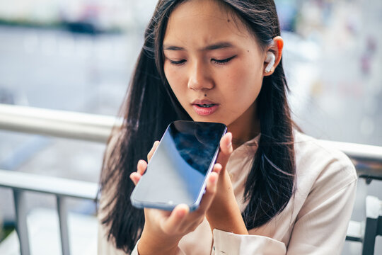woman talking and command an AI voice assistant on a smartphone as a conceptual backdrop for artificial intelligence technology communication phone innovation virtual assistant and smart lifestyle