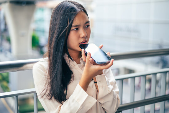 woman talking and command an AI voice assistant on a smartphone as a conceptual backdrop for artificial intelligence technology communication phone innovation virtual assistant and smart lifestyle