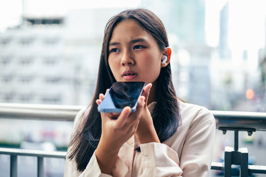 woman talking and command an AI voice assistant on a smartphone as a conceptual backdrop for artificial intelligence technology communication phone innovation virtual assistant and smart lifestyle
