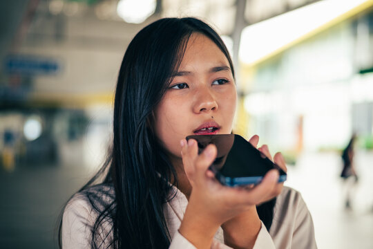 woman talking and command an AI voice assistant on a smartphone as a conceptual backdrop for artificial intelligence technology communication phone innovation virtual assistant and smart lifestyle