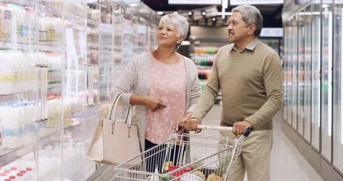 Smile, old couple and shopping at store for groceries, selection and fresh milk for household. Happy, senior people and trolley in supermarket with ingredients, dairy products and food essentials
