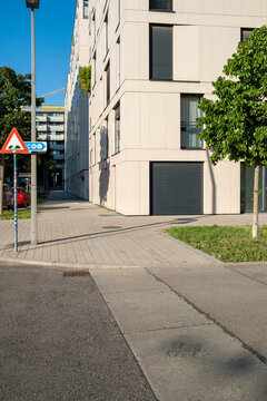 Modern residential corner with sidewalk trees and traffic sign in Nordbahnviertel Vienna Austria showing clean contemporary streetscape design