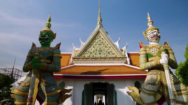 Ornate Entrance To The Ordination Hall At Wat Arun, Guarded By Towering Yaksha Demon Statues In Bangkok, Thailand. Dolly Tilt-up Shot