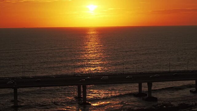 4k aerial view of Mumbai Sea link during sunset in Monsoon. Golden hour view of the Arabian Sea with cars running on the bridge. 