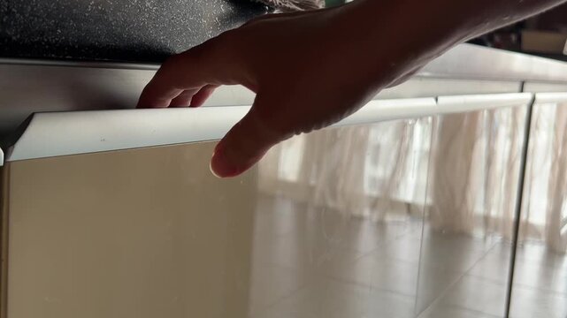 A kitchen drawer slides open and closed by hand, capturing everyday home organization and realistic drawer movement with authentic sound. High quality FullHD footage