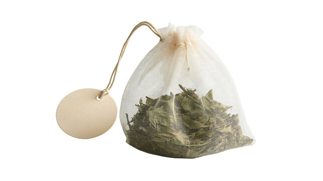 Small sheer fabric drawstring tea bag filled with dried green herbal tea leaves