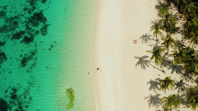 Sandy tropical beach with tourists and blue clear sea. Summer and travel vacation concept. Boracay, Philippines. Seascape with beach on tropical island. Puka shell beach