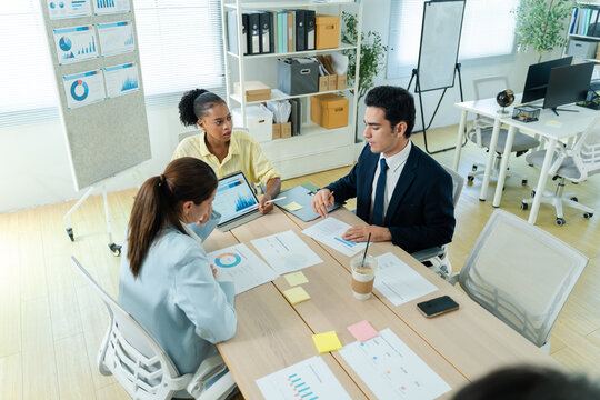 business people meeting and discussion in the office while working on a company project.Business teamwork and team doing corporate research in discussion together with technology in workplace