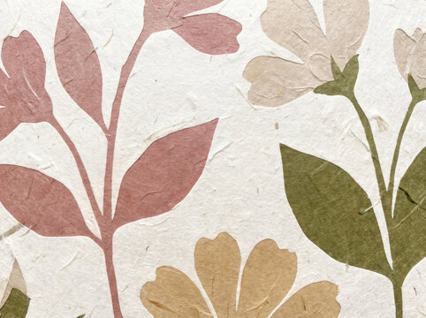 Pressed botanical flowers on textured handmade paper background