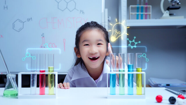Asian student girl learning science in laboratory pointing at glowing holographic lightbulb icon representing creative innovation and discovery for stem education and digital e-learning concepts
