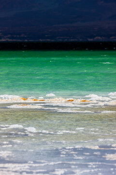 Salt crystals form white patches along the shoreline of Lake Assal, Dikhil Region, Lake Assal, Djibouti