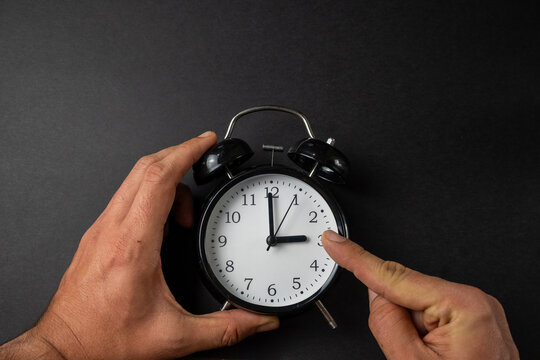 Hands Adjusting Clock Time Change