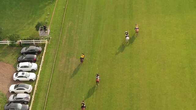 Aerial view of a professional polo match on a green field