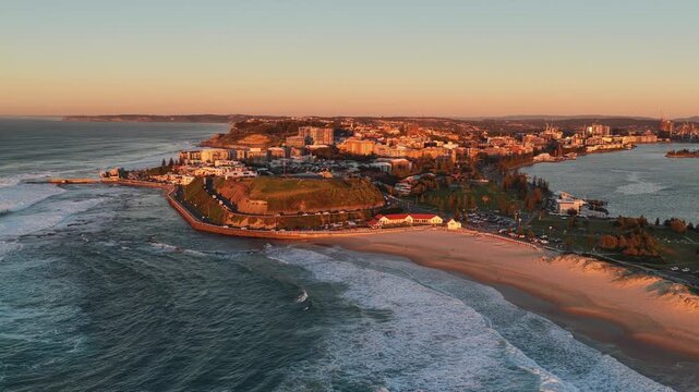 Newcastle beach city public baths rock pool on Pacific coast in Australia &ndash; aerial sunrise.