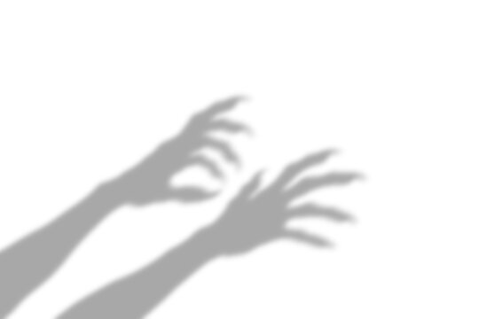 A dark scary shadow of monster hands with sharp claws reaching forward to grab something presented as an isolated object isolated on transparent background