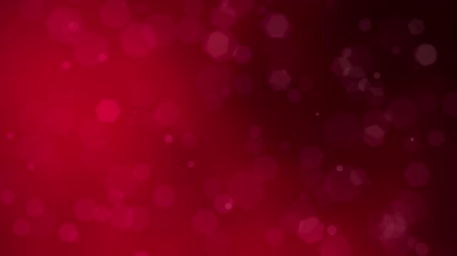 This abstract deep red background features shimmering hexagonal bokeh lights that create a festive and romantic atmosphere for holiday designs.