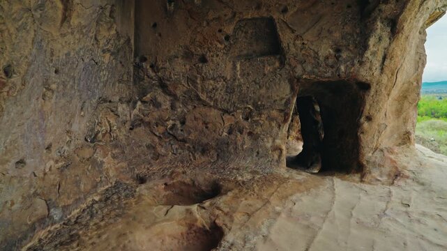 The hollowed walls and doorway of a rock cut chamber show the chisel marks of the ancient cave city of Uplistsikhe.