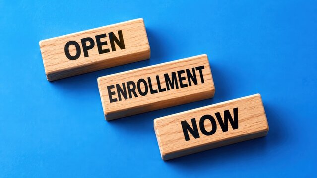 Wooden blocks spell out open enrollment now for educational institutions and student registration.