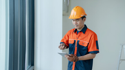 Professional construction engineer using a digital tablet for site inspection and planning © Naypong Studio