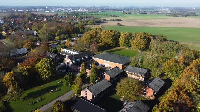 Houses surrounded by mature trees in Gammel Ega residential area near Aarhus, Denmark, aerial