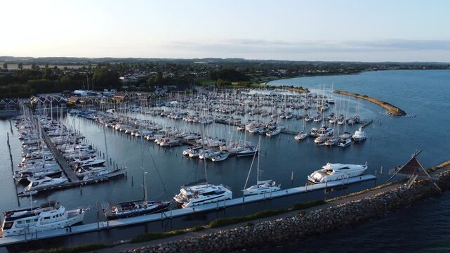 Ega Marina filled with sailboats and docks along the coast near Aarhus, Denmark, aerial