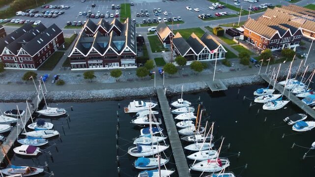 Ega Marina sailboats and waterfront buildings near Aarhus, Denmark at evening, aerial