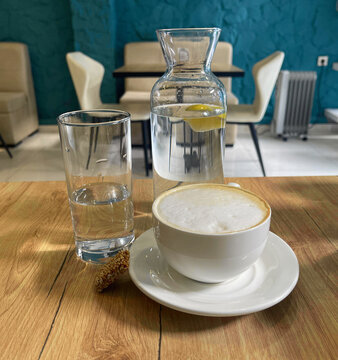 cappuccino cup and water jur on the table