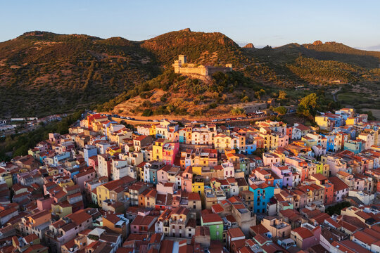 Old town castle and colorful houses at Sunset in bosa Sardinia Italy
