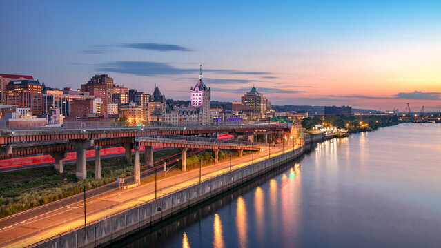 Albany, New York, USA. Cityscape image of Albany, New York with reflection of the city skyline in the water at beautiful sunrise.