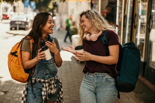Friends traveling together laughing and enjoying urban life