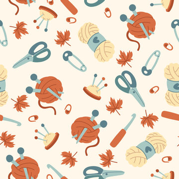 Vector seamless knitting pattern with yarn, needles, scissors, pins, crochet hook, buttons and autumn leaves. Hand drawn cozy craft texture background for textile, fabric, wrapping paper, hobby print