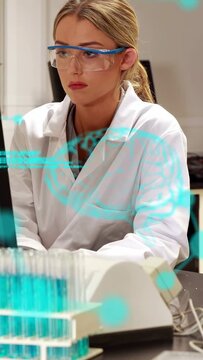 Vertical video: Lab tech glancing at monitor and tubes after AR HUD pulsing, monitoring results