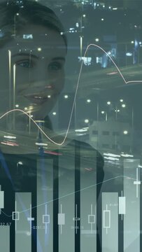 Vertical video: Woman watching stock feed and tracking moves as charts, numbers animating in glass