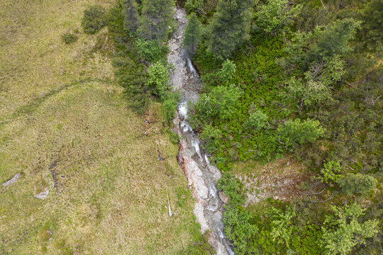 Alpine wilderness and nature conservation, aerial view of a mountain stream flowing through the Kitzb&uuml;hel Alps in the Hohe Tauern National Park in austria