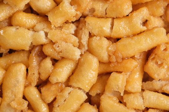 Top view macro background golden honey soaked crispy pastry pieces from traditional chak chak.