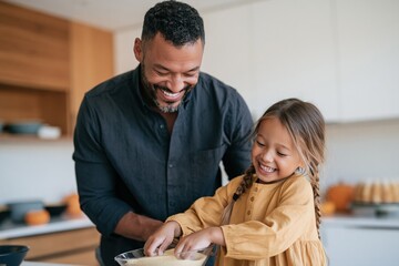 Obraz premium Father and daughter baking together in a bright kitchen with pumpkins for thanksgiving greeting card and seasonal family cooking scenes